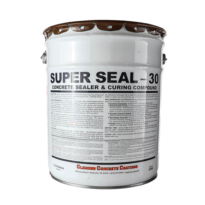 A white metal bucket of Super Seal 30 Concrete Sealer & Curing Compound, featuring a detailed instruction label and brown metal rims on the lid, isolated on a white background.
