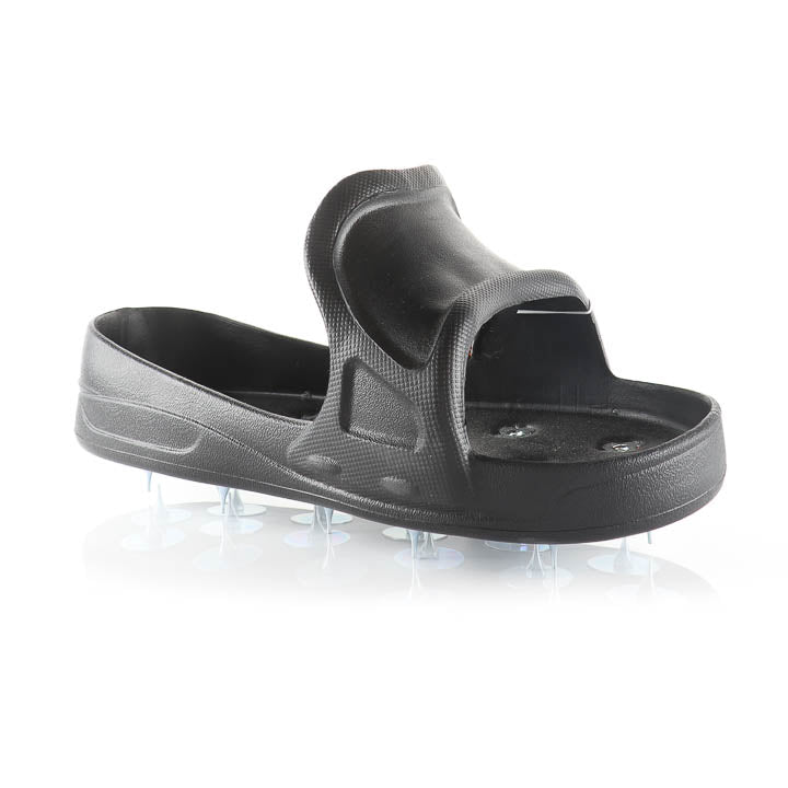 Side view of a black spiked over-shoe slip-on designed for walking on wet epoxy coatings.