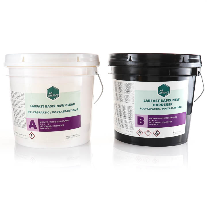 Two plastic buckets of Labfasts Basix New Hardener and Clear polyaspartic mix components on a white reflective background. The left bucket is white with a clear lid and label showing 'LABFASTS LAB FAST BASIX NEW CLEAR', and the right bucket is black with a black lid and label showing 'LABFASTS LAB FAST BASIX NEW HARDENER'.