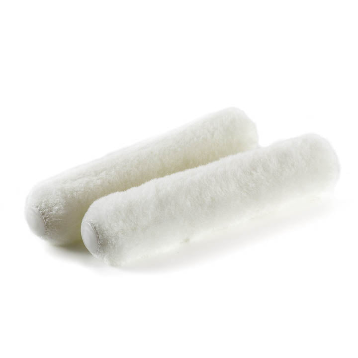 2 Brushman 6" white Rollers on reflective white background 