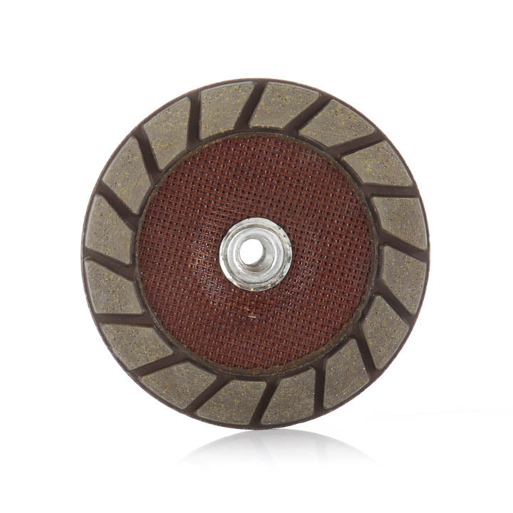 Bottom view of 7-inch SASE QuikCut grinding cup wheel showing angled diamond segments and central mounting arbor.