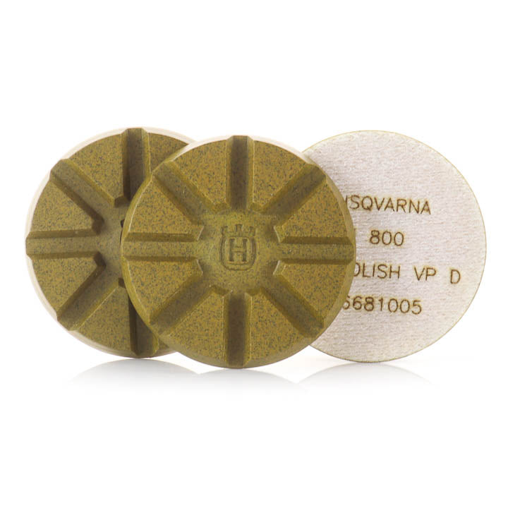 Three 3-inch Husqvarna Vari-Polish 800-grit silver resin diamond polishing pucks laid flat, showing the embossed logo and grit markings.